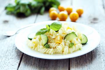 Plate of penne pasta on plate of grey wooden background