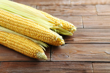 Sweet corns on a brown wooden table