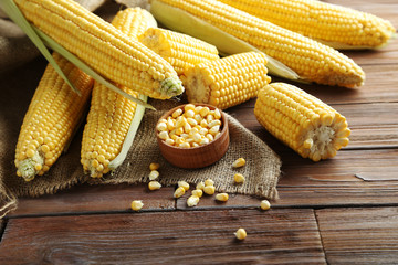 Sweet corns on a brown wooden table