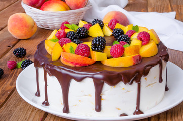 Vanilla mousse cake with peaches and chocolate glaze
