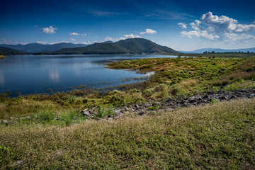 Fototapeta na wymiar Lake with mountain and blue sky background