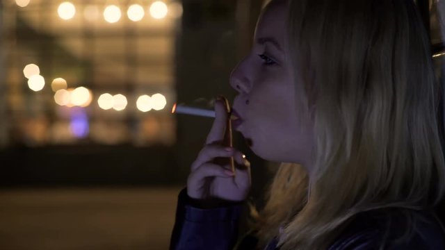 Depressed woman smoking and thinking about breakup, problem, unhealthy lifestyle