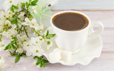 Cup of coffee and spring flowers