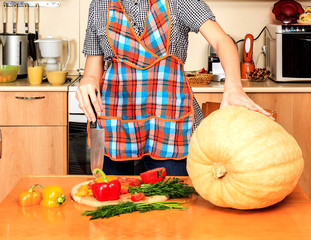 Housewife ready to prepare big pumpkin