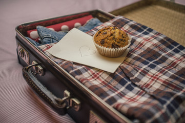 Suticase, muffin and a love letter