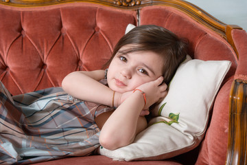 little girl sleeping on the sofa