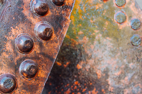 Close-up macro of iron rivets on a rusted iron beam