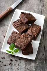 Chocolate brownie pieces on wooden background
