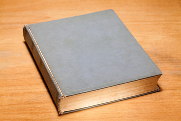 Old book on wooden background.