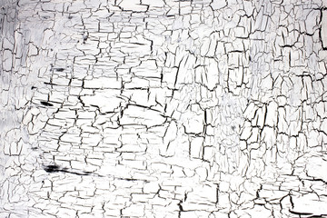 Cracked white paint on a black surface