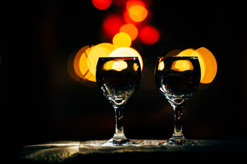 two wine glasses and defocused lights at the restaurant