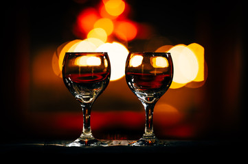 two wine glasses and defocused lights at the restaurant