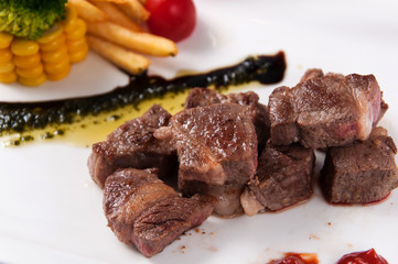 Fried beef with French fries and corn