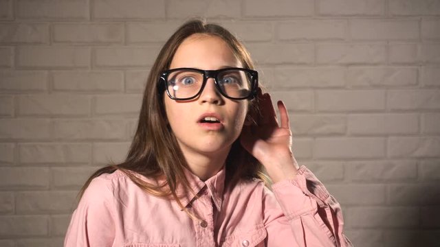 Teen girl trying to hear something