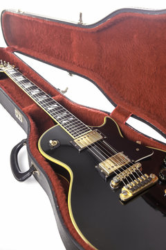 Sexy black and gold guitar in red fur lined case