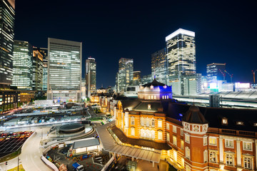Fototapeta na wymiar Asia Business concept for real estate and corporate construction - panoramic modern cityscape building bird eye aerial night view of Tokyo Station under neon light and dark blue sky in Tokyo, Japan