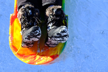 Snow Boots in Sled on Snow Winter Time Playing