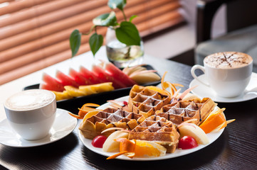 Muffin with fruit and Coffee beside the window