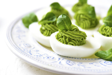 Eggs stuffed with avocado and spinach.