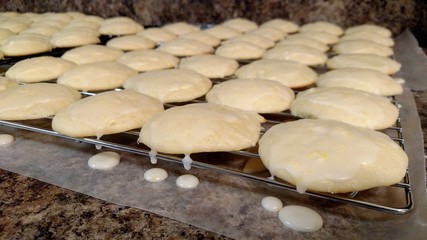 Rows of Lemon cookies on cooling rack with dripping icing