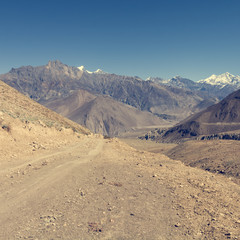 Desert road towards mountains.