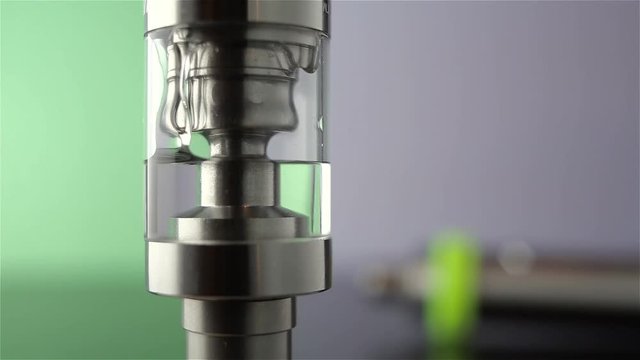 Filling of a tank for an electronic cigarette liquid close up. Rebuildable dripping atomizer (RDA). Electronic nicotine delivery systems. ENDS.