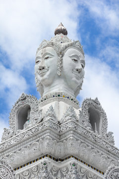 White statue of buddha image with blue sky and cloud