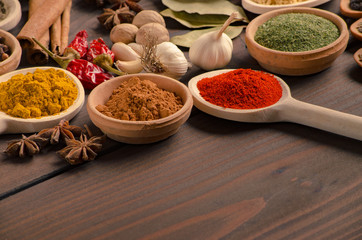 Various kinds of spices on wooden table