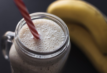 Healthy smoothie on gray background. Banana,oats,chia seeds and honey mix. 