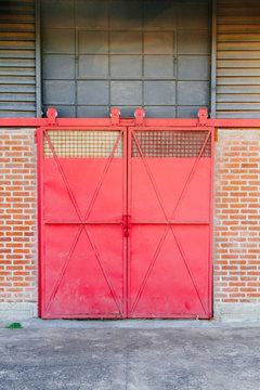 Red sliding gate in the front of a warehouse