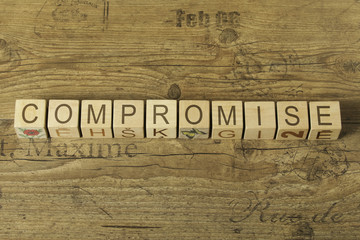 compromise word on wooden background