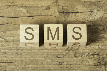 sms word on wooden background