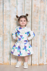 little girl in dress with violet flowers
