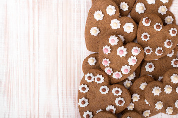 Heart shaped cookies on white wooden background