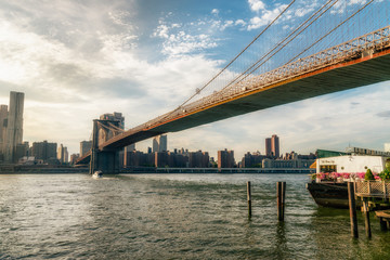 Fototapeta na wymiar Brooklyn bridge. The bridge is often featured in wide shots of the New York City skyline in television and film. Splittoned vivid image.