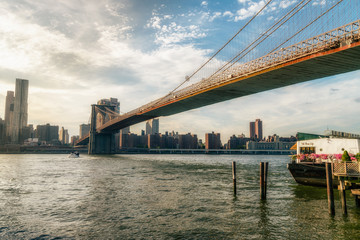 Fototapeta na wymiar Brooklyn bridge. The bridge is often featured in wide shots of the New York City skyline in television and film. Splittoned vivid image.