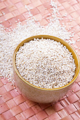 barley groats in a brown bowl
