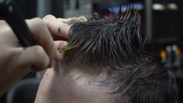 Man getting a haircut by a hairdresser
