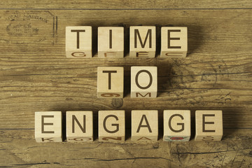 time to engage text on cubes on wooden background