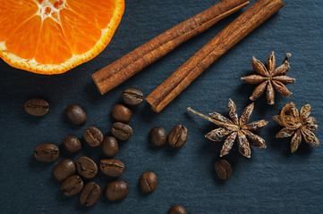 Ingredients: anise star, cinnamon sticks, coffee beans and tangerine. Top view
