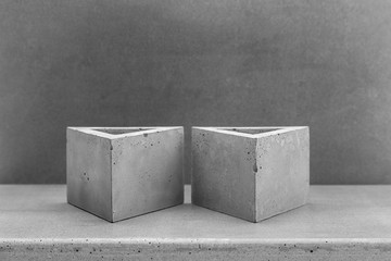 Planters of concrete on grey background