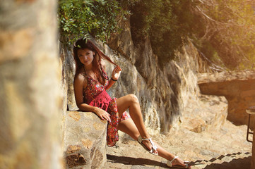Obraz premium Hot summer portraite of romantic sexy woman in red dress