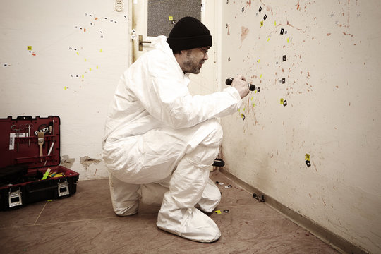 Criminologist technician at work on evidences of blood stains