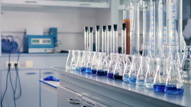 Conical flasks are standing in rows on the table.