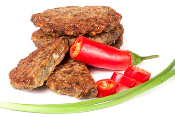 liver pancakes or cutlets with chili pepper and green onions isolated on white background