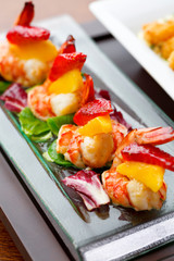 set of finger food - shrimps with mango and strawberry