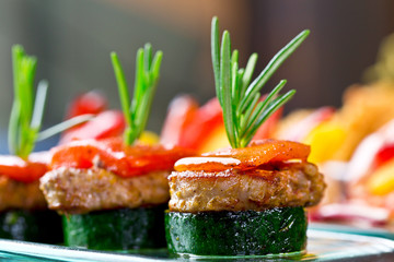 set of finger food - zucchini, grilled pork, red pepper and rosemary