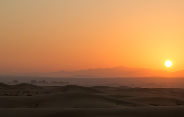Hot sunrise in the desert dunes of Dubai, United Arab Emirates.