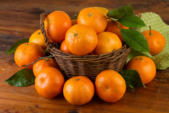 mandarin tangerine fruit basket on wooden table