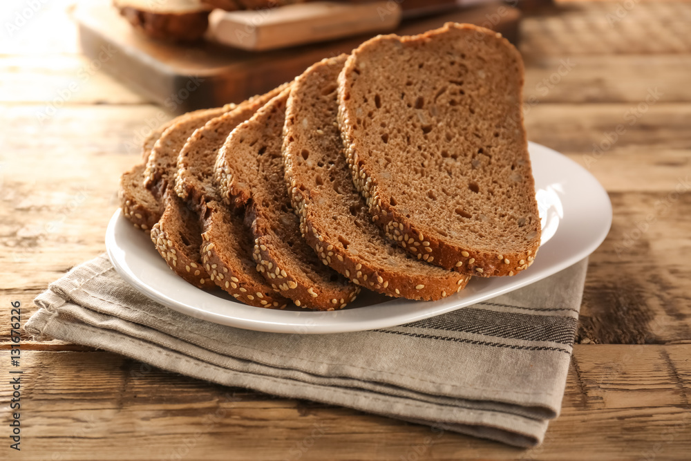 Poster sliced rye bread on wooden table closeup